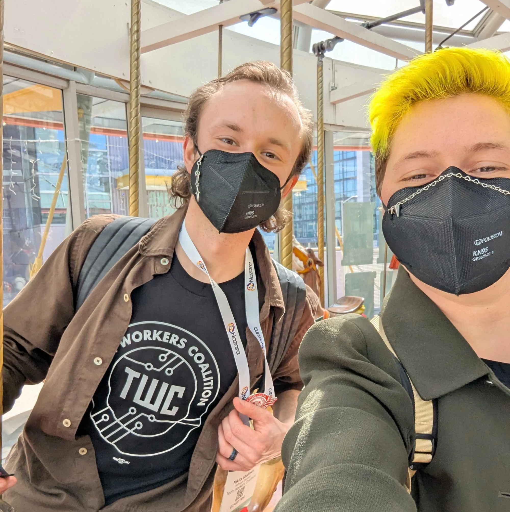 two tech workers, one is wearing a tech workers coalition shirt