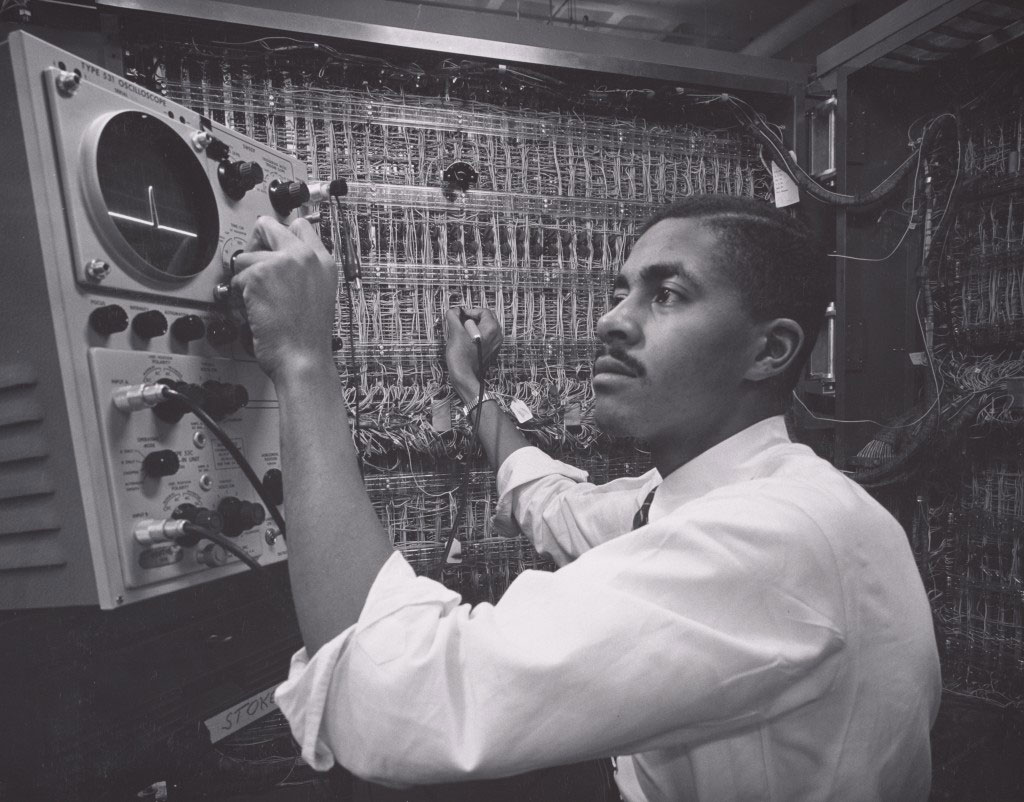 A Black engineer seated at an IBM mainframe, 1956